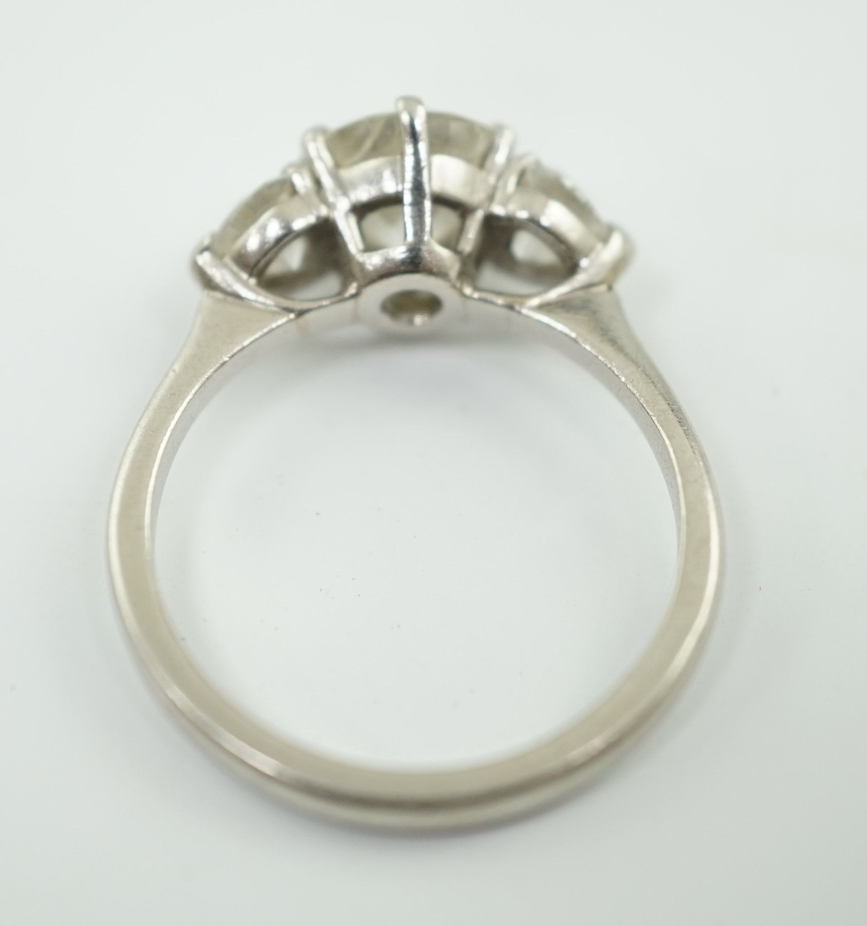 A modern Boodles & Dunthorne platinum and single stone diamond ring, with two stone heart shaped diamond set shoulders